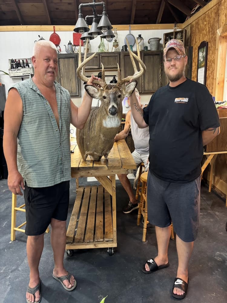 Robert Carmicle and a customer with a deer mount from Buck Creek Taxidermy & Tannery.